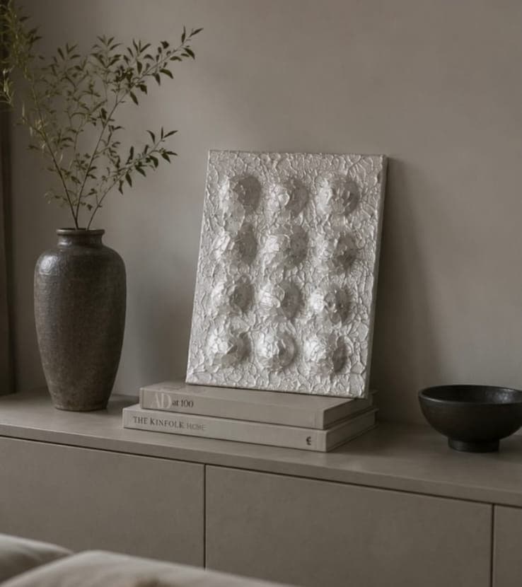 Litany: white textured relief of twelve carved circles